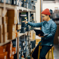 An AAPI man browses through records at a reference institution.