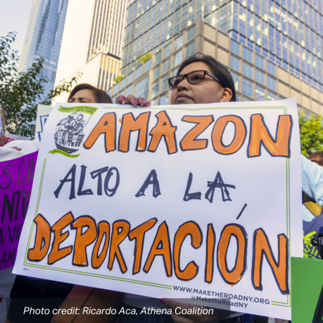 A Lanitx woman marches with Make the Road NY, holding a sign that reads: "Amazon Alto A La Deportacion". photo credit: Ricardo Aca, Athena Coalition