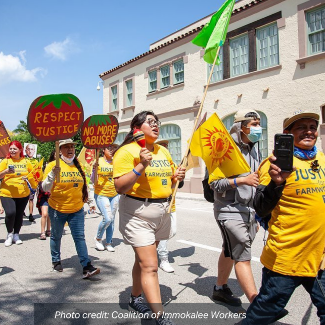 Marchers wearing yellow tshirts that read: "Justice for Farmworkers". They carry tomato-shaped signs that read: "Respect Justice", "No More Abuses". photo credit: Coalition of Immokalee Workers