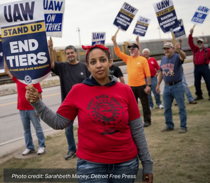 Erika Mitchell, 36, of Toledo, Ohio, center, stands with skilled trades workers outside Stellantis' Toledo Assembly Complex in Toledo, Ohio, on Tuesday during the UAW strike against Ford Motor Co., General Motors and Stellantis. photo credit: Sarahbeth Maney, Detroit Free Press