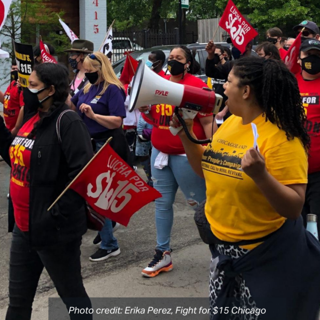 Erika Perez of Fight for $15 Chicago speaks into a bullhorn during a march. photo credit: Erika Perez, Fight for $15 Chicago