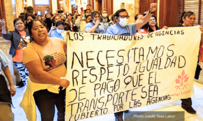 New Labor mambers march holding a sign that reads: "Los Trabajadores De Agencias - Necesitamos Respeto Igualidad De Pago Que El Transporte Sea Cubierto Por Las Angencias". photo credit: New Labor