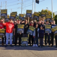 Group of Long Island Amazon Teamsters workers and their families hold Strike signs.