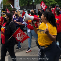 Erika Perez of Fight for $15 Chicago speaks into a bullhorn during a march. photo credit: Erika Perez, Fight for $15 Chicago