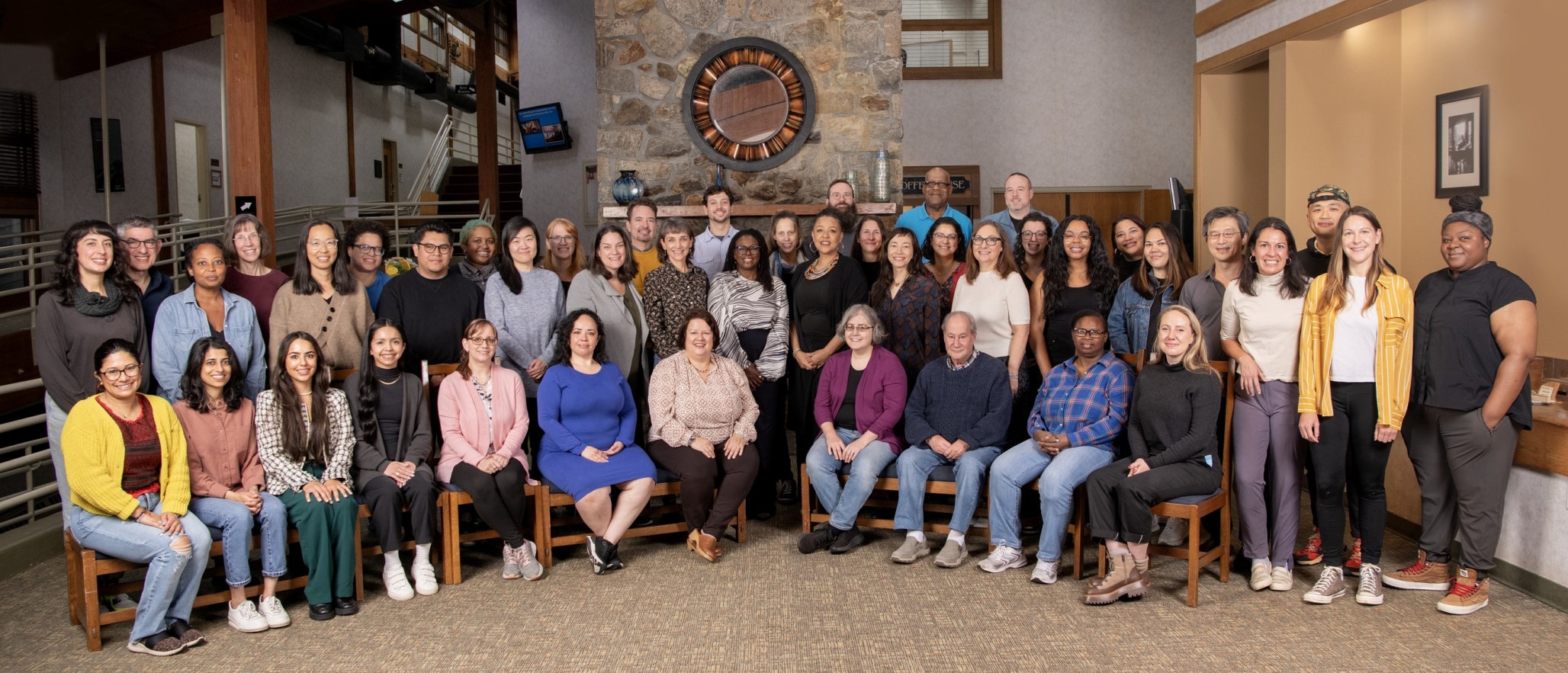 A group of fifty NELP Staff pose for a group portrait in 2023.